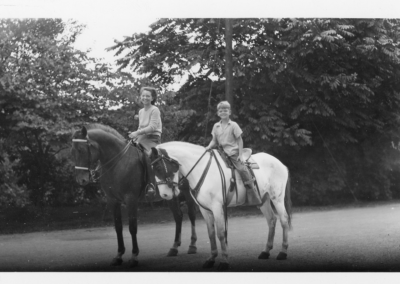 Doug and his mother, Lecretia, on horseback. The alley across the street was a major route through to the park and the Basts had a large barn, chicken house.