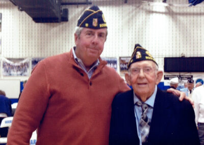 Bud Price with arm around Jim Bowers at a Veterans event at Boonsboro High School